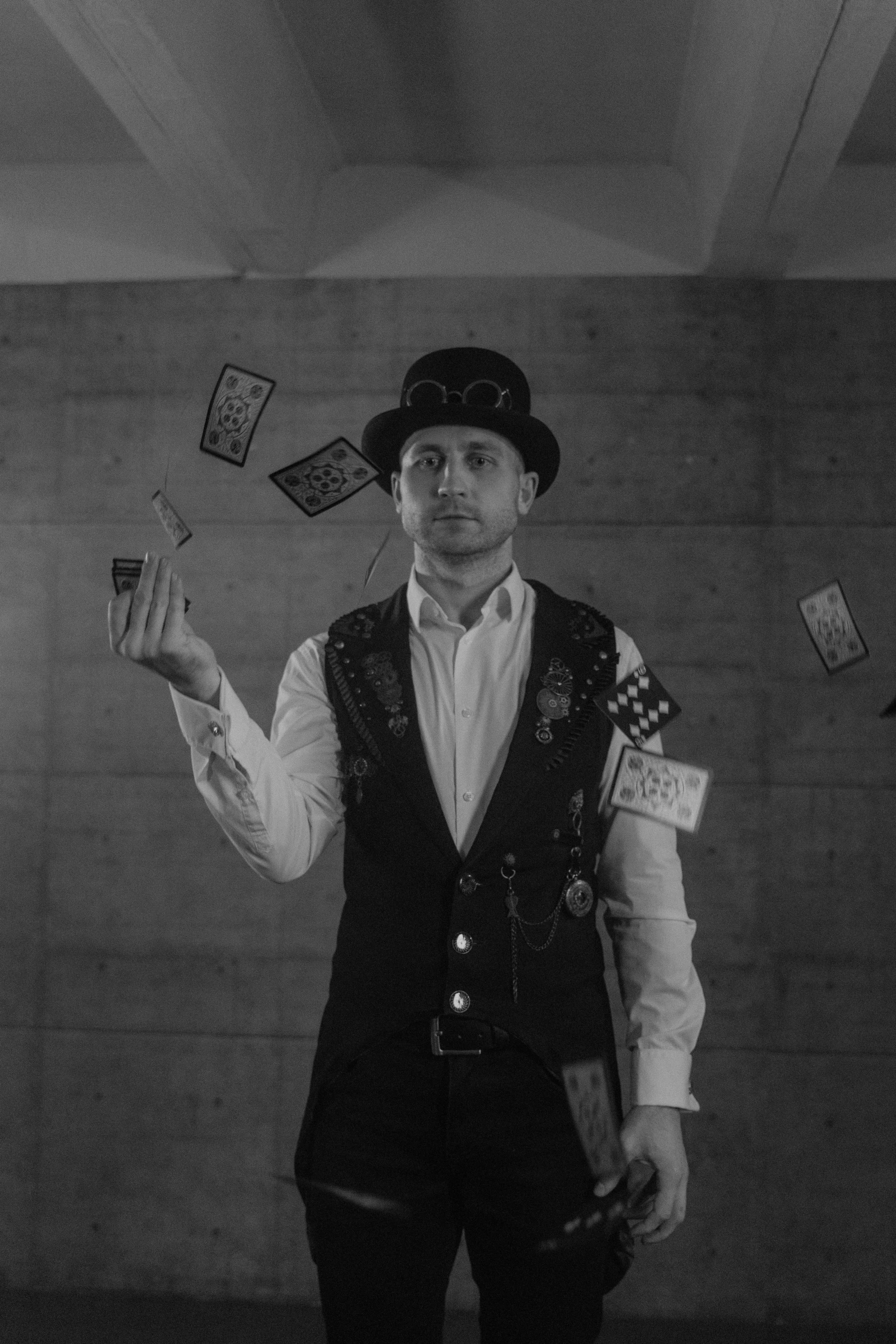 a black and white photo of a man juggling with cards, costumes from peaky blinders, jakub rebelka, ( ( theatrical ) ), official music video