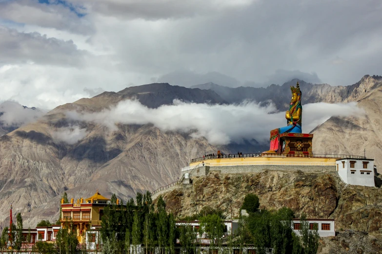 a large statue sitting on top of a mountain, pexels contest winner, samikshavad, tibetan inspired architecture, avatar image