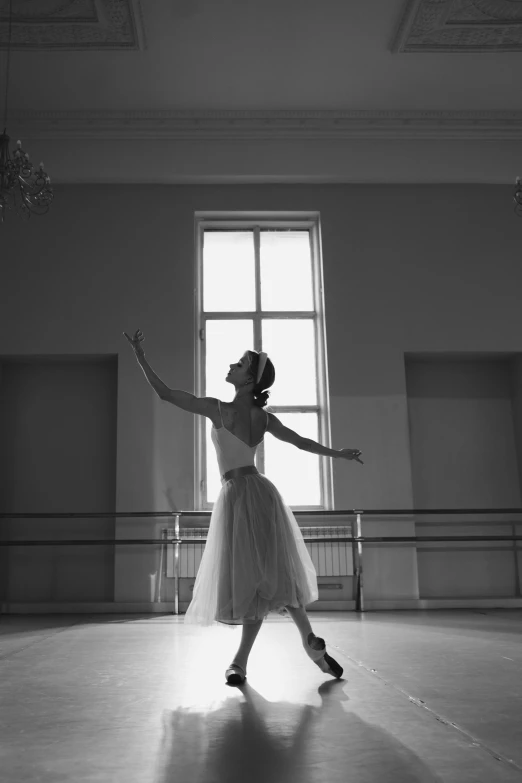 a black and white photo of a ballerina in a dance studio, by Elizabeth Polunin, beautiful surroundings, michal mraz, getty images, window