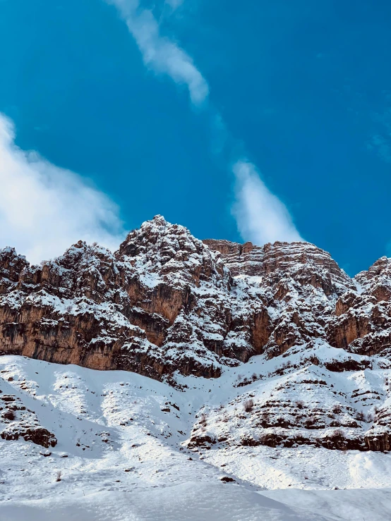 a group of people riding skis down a snow covered slope, a matte painting, pexels contest winner, les nabis, extremely detailed rocky crag, mardin old town castle, today\'s featured photograph 4k, hiking in rocky mountain