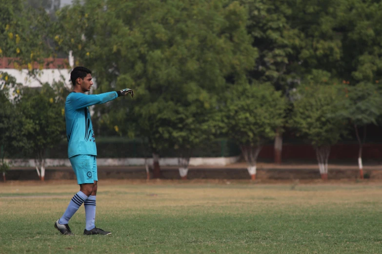 a young man standing on top of a lush green field, a picture, tournament, profile image, training, vastayan