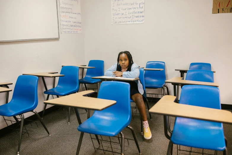 a girl sitting at a desk in a classroom, a portrait, by Carey Morris, trending on unsplash, ashcan school, : kendrick lamar, sitting on chair, 2000s photo, 15081959 21121991 01012000 4k