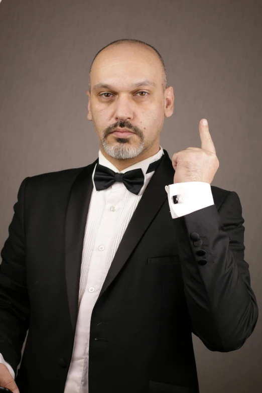 a man in a tuxedo posing for a picture, inspired by Edi Rama, les nabis, angry and pointing, gaspar noe, professional profile photo, professional profile picture