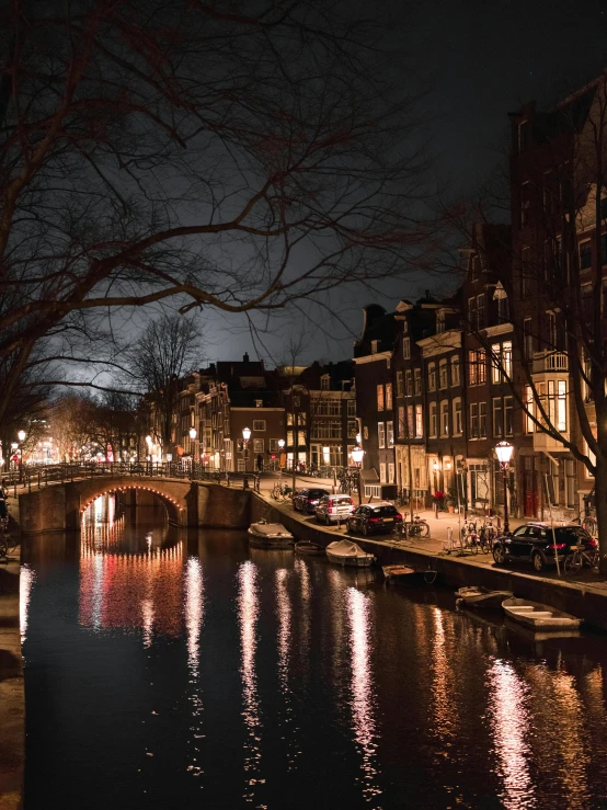 a river running through a city at night, dutch houses along a river, slide show, candlelit, canals