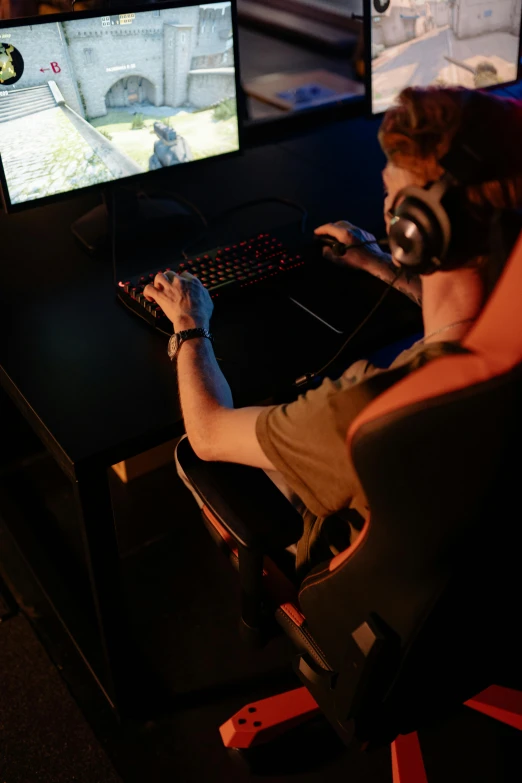 a man wearing headphones playing a video game, bottom lighting, game environment, no - text no - logo, a high angle shot