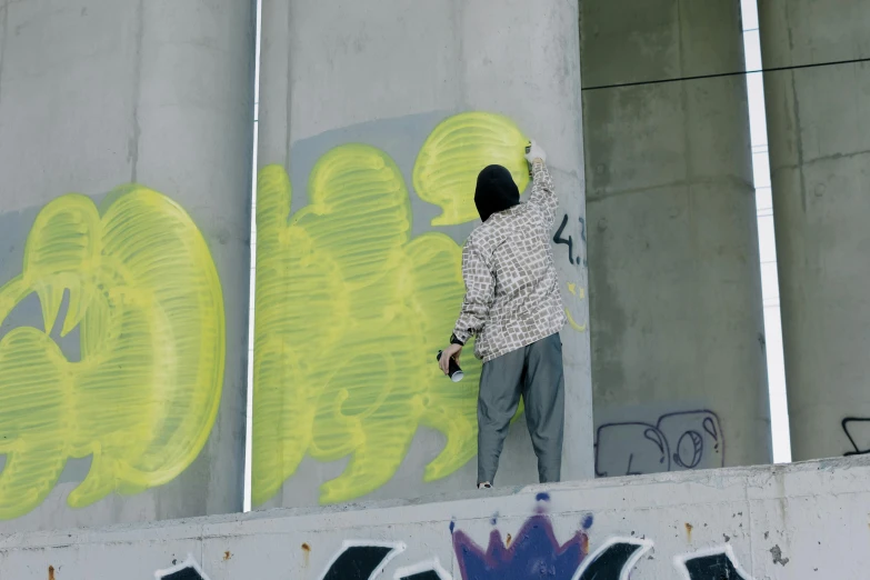 a man is painting graffiti on the side of a building, unsplash, digital ilustration, overpass, animation still, toxic drips