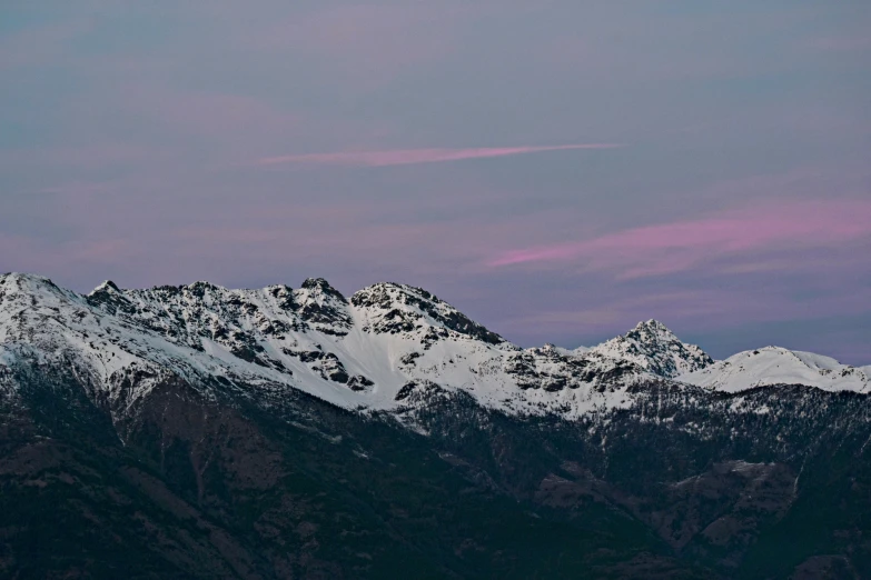 a plane flying over a snow covered mountain range, by Peter Churcher, pexels contest winner, visual art, late summer evening, white and purple, pink hues, slightly pixelated