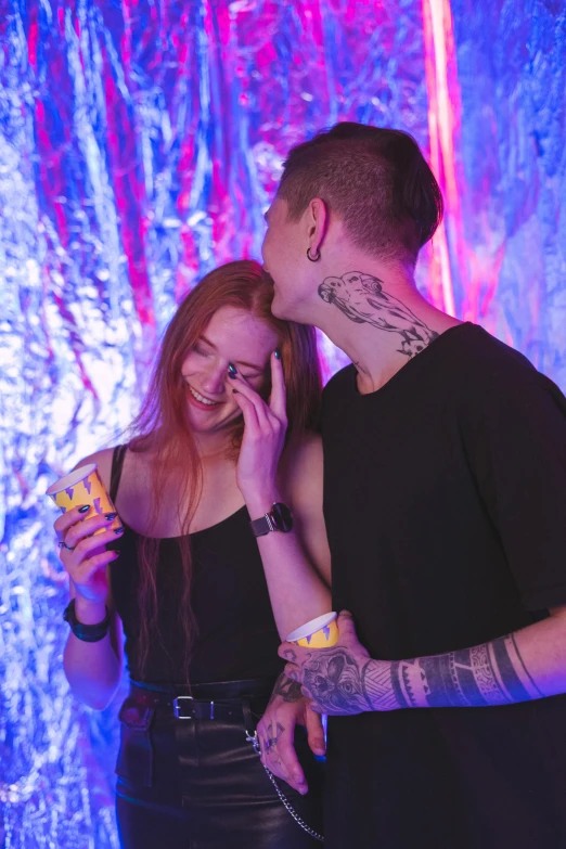 a man and a woman standing next to each other, a tattoo, trending on pexels, graffiti, partylights, eating, teen, ( redhead