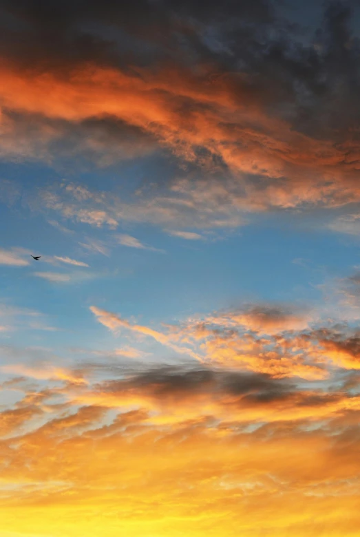 a plane flying in the sky at sunset, by Linda Sutton, pexels contest winner, minimalism, red cloud, today\'s featured photograph 4k, birds overhead, orange and blue colors