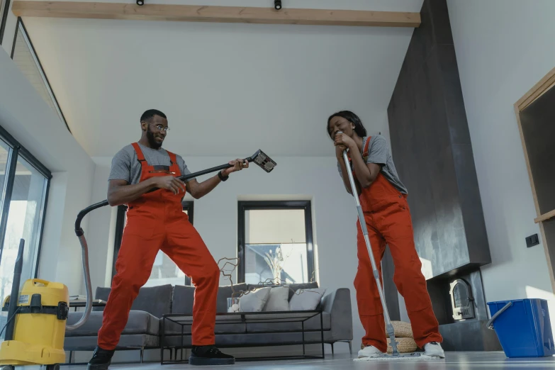a couple of men standing on top of a hard wood floor, pexels contest winner, arbeitsrat für kunst, attacking with axe, home video footage, in orange clothes) fight, mkbhd