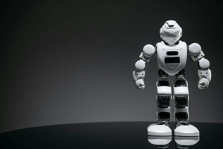 a close up of a robot on a table, on a gray background, standing with a black background, best ai image, instagram photo