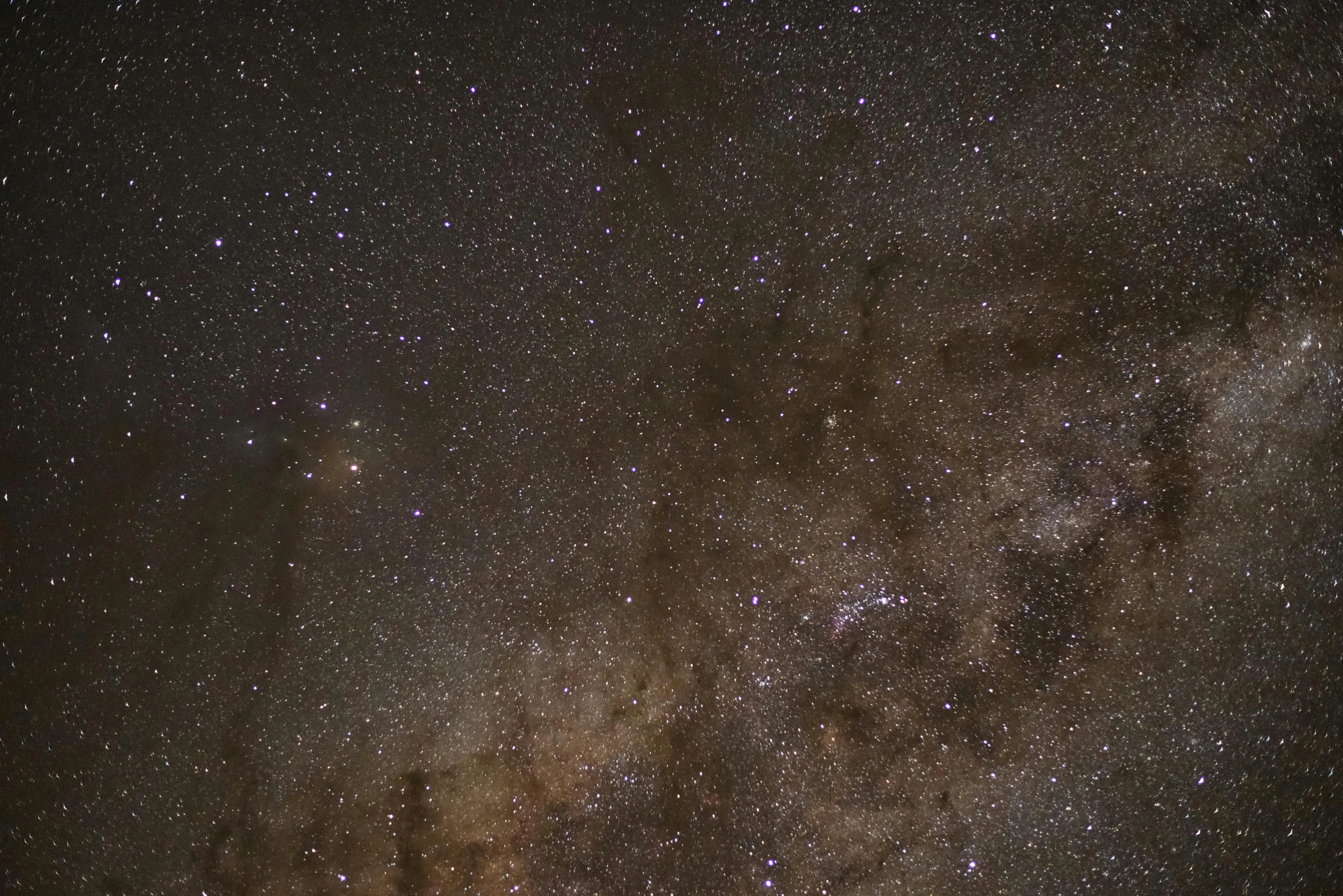 a dark sky filled with lots of stars, by Doug Wildey, light and space, full frame image, brown, neck zoomed in, ultrawide image