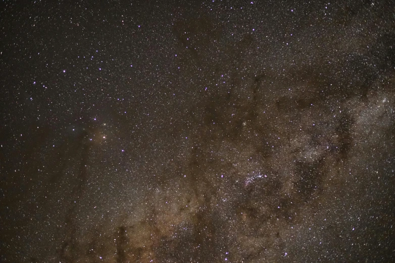 a dark sky filled with lots of stars, by Doug Wildey, light and space, full frame image, brown, neck zoomed in, ultrawide image