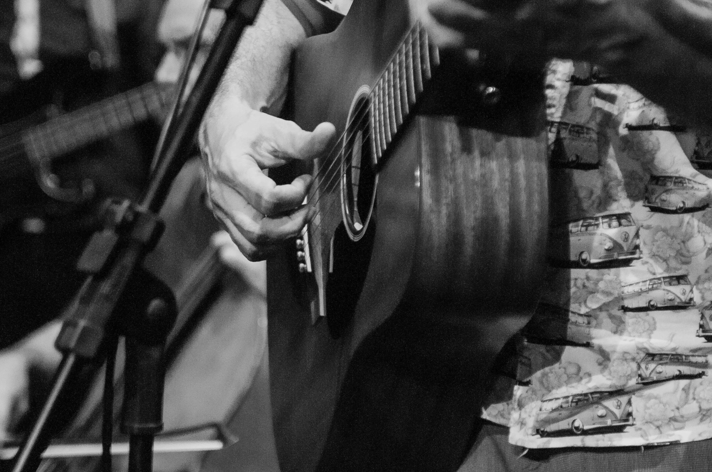 a black and white photo of a man playing a guitar, by Mike Bierek, detail, uploaded, folk, playing guitar onstage