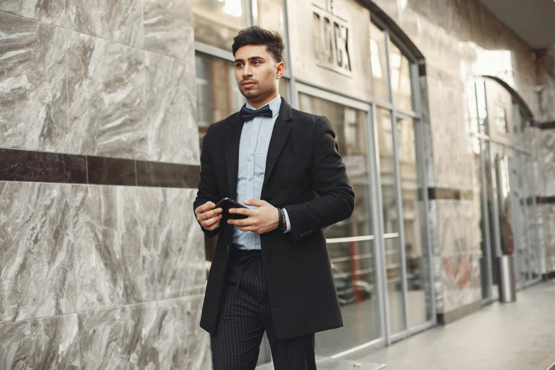 a man in a suit standing in front of a building, pexels contest winner, ilya kuvishinov style, attractive male, thumbnail, black overcoat