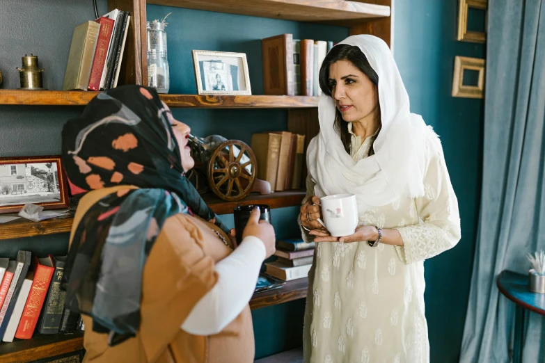 a couple of women standing next to each other, inspired by Maryam Hashemi, pexels contest winner, hurufiyya, secret tea society, tv show still, production photo, shohreh aghdashloo