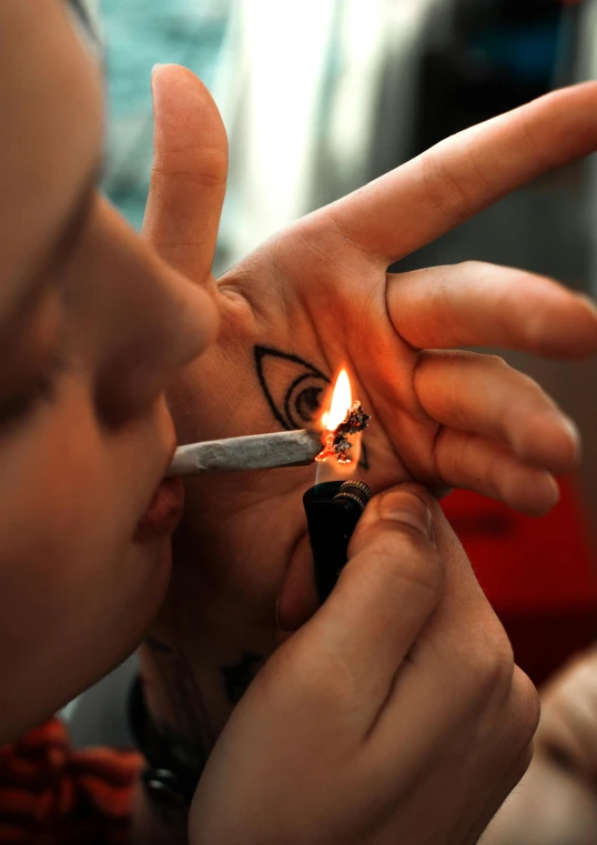 a person lighting a cigarette with a lighter, a tattoo, smoke out of eyes, lgbtq, temporary tattoo, deity)