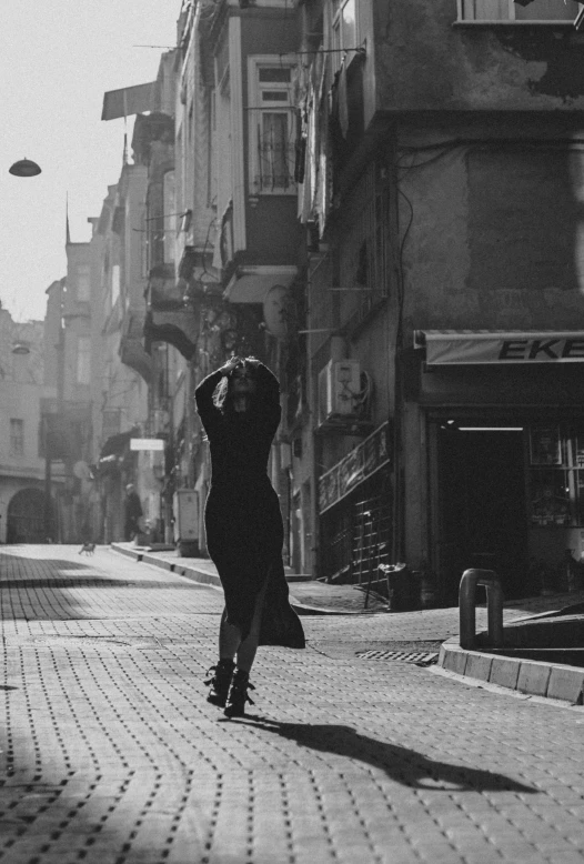 a black and white photo of a person on a skateboard, a black and white photo, inspired by Peter Lindbergh, pexels contest winner, arabesque, ancient city streets behind her, :: morning, istanbul, dancing elegantly over you