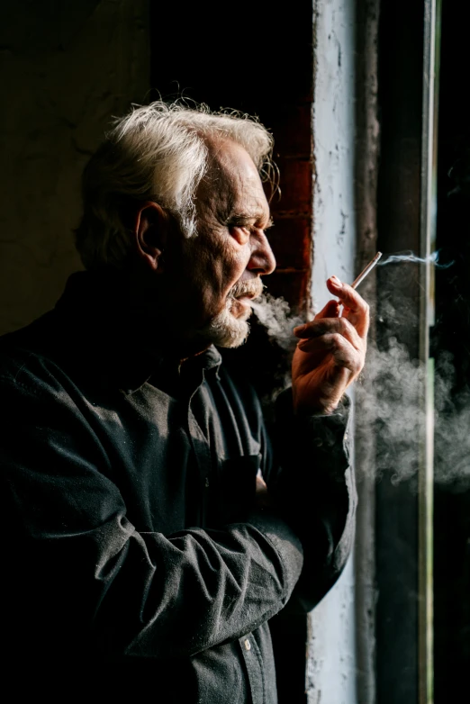 a man smoking a cigarette in front of a window, a portrait, pexels contest winner, cloud-like white hair, profile image, scruffy man, a photo of a man