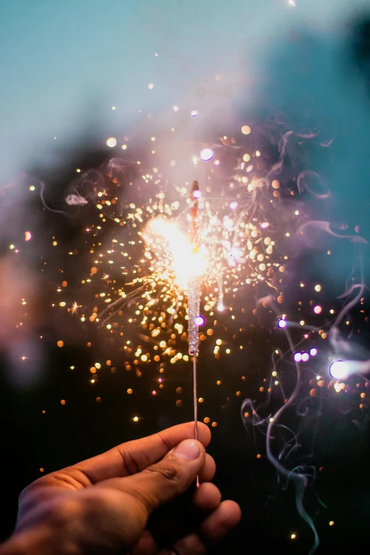 a person holding a sparkler in their hand, pexels contest winner, instagram post, fourth of july, with sparkling gems on top, incense