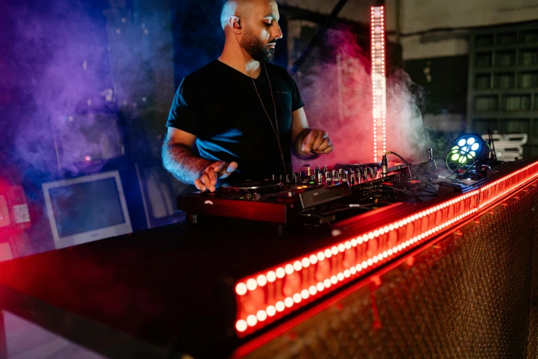 a man that is standing in front of a dj, nadir lighting, rectangle, uploaded, brown