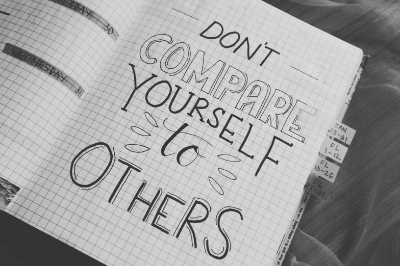 a notebook with the words don't compare yourself and others written on it, pixabay, sots art, b&w!, instagram picture, 🕹️ 😎 🚬, compassion