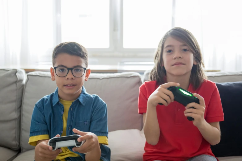 two children sitting on a couch playing a video game, 15081959 21121991 01012000 4k, high-quality photo, medium head to shoulder shot, various posed