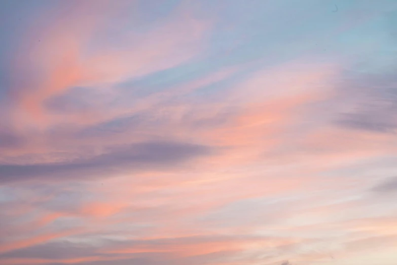 a man flying a kite on top of a lush green field, unsplash, pink sunset, altostratus clouds, pastel pink, steven outram