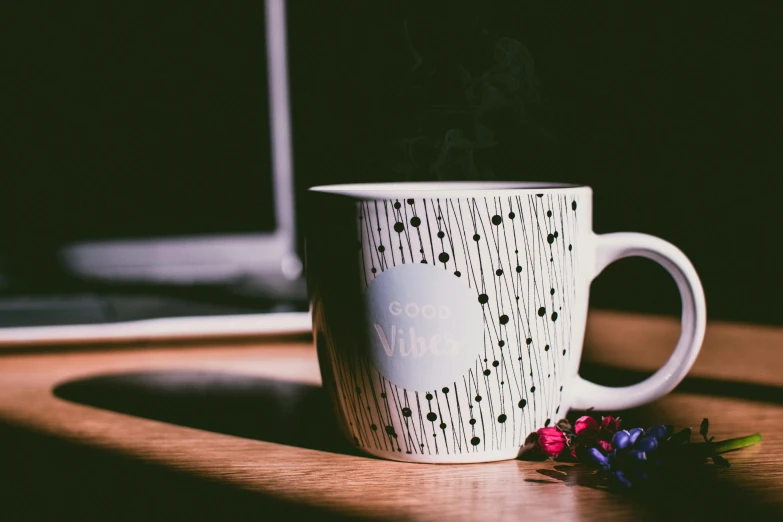 a coffee cup sitting on top of a wooden table, by Arabella Rankin, pexels contest winner, polka dot, computer wallpaper, good vibes