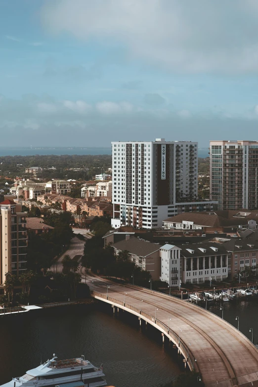 a bridge over a body of water next to tall buildings, by Ryan Pancoast, pexels contest winner, renaissance, the emerald coast, panoramic view, sunfaded, high angle view