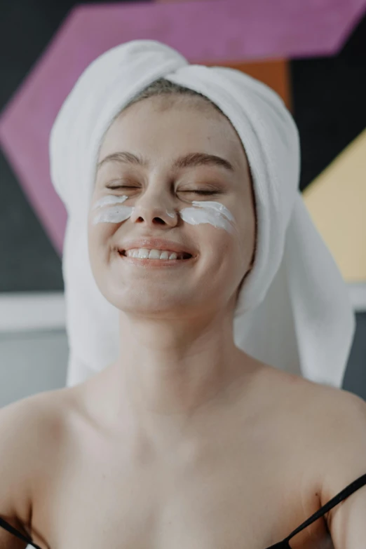 a woman with a towel wrapped around her head, trending on pexels, aestheticism, a still of a happy, white face paint, candy treatments, shaved temple