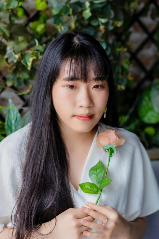 a woman with long black hair holding a flower, long white hair and bangs, taken with sony alpha 9, holding a rose, li zixin