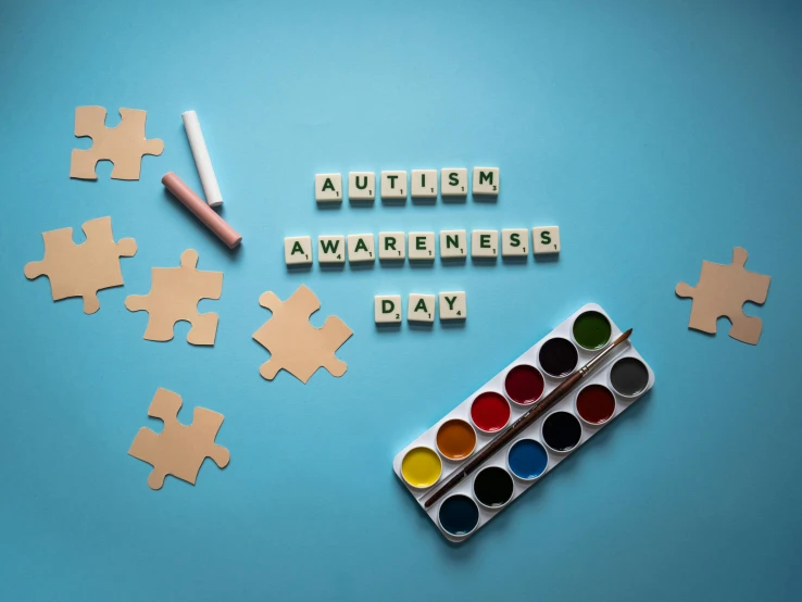puzzle pieces with autism awareness written on them, by Julia Pishtar, trending on pexels, paintbrush and palettes, taken from the high street, whiteboards, zee day