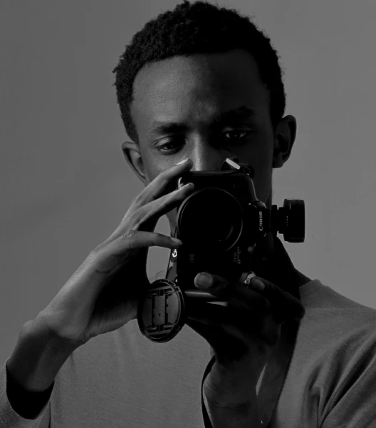 a man taking a picture with a camera, a black and white photo, by Afewerk Tekle, portait photo profile picture, avatar image, uploaded, nuri iyem