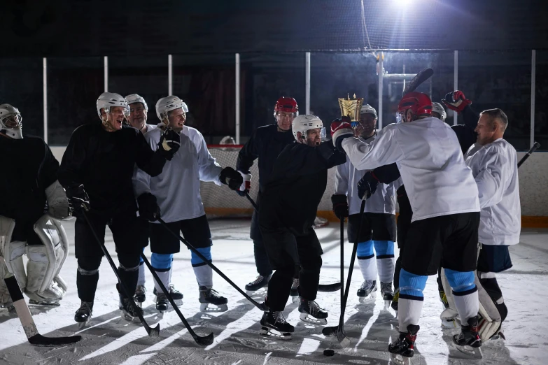a group of men standing next to each other on top of an ice rink, sparring, on set, under light, sports illustrated