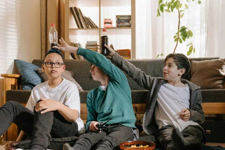 a group of young men sitting on top of a couch, pexels, kids playing, nerds, sitting in a lounge, superbowl