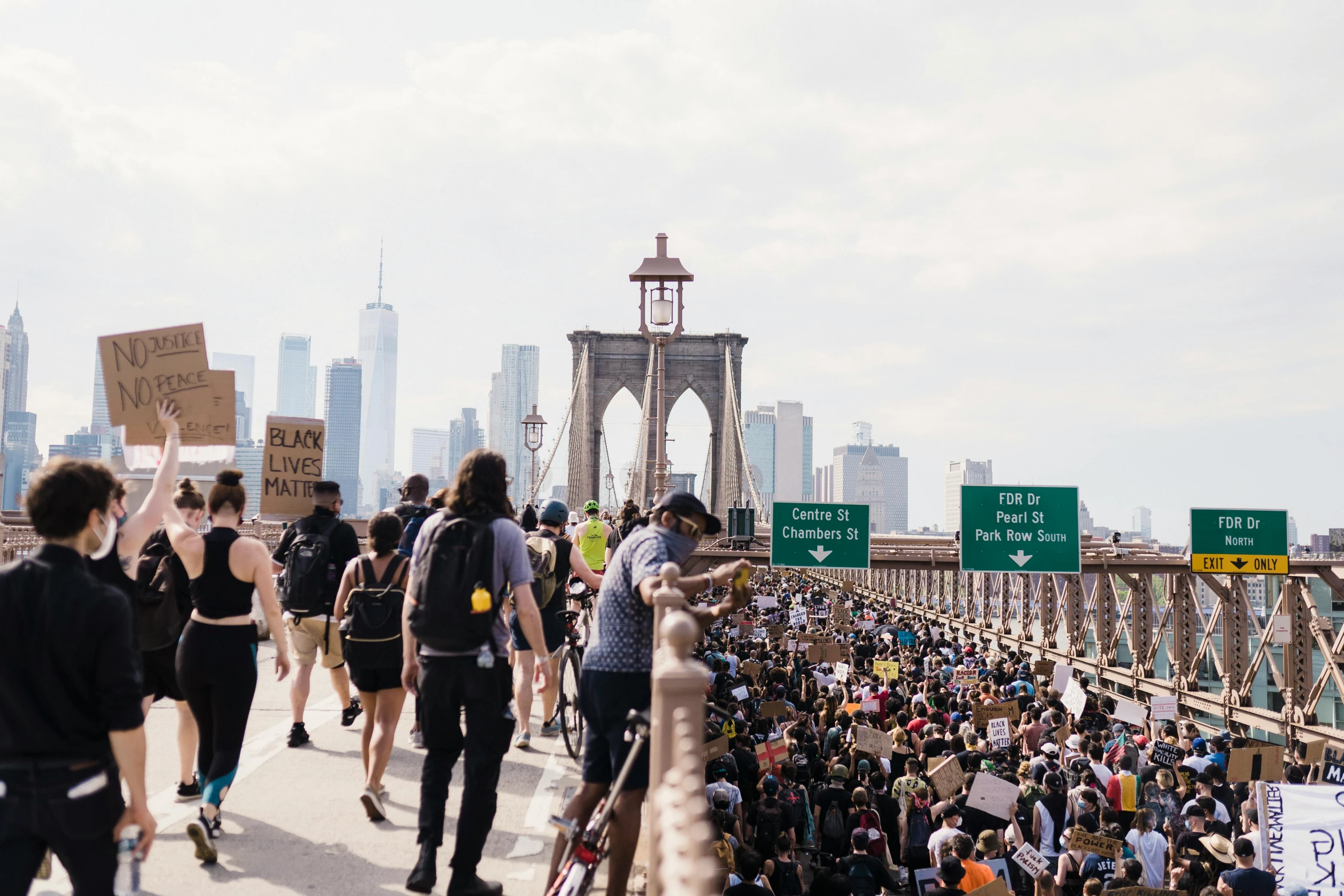 a group of people walking across a bridge, protest movement, brooklyn background, unsplash photography, background image