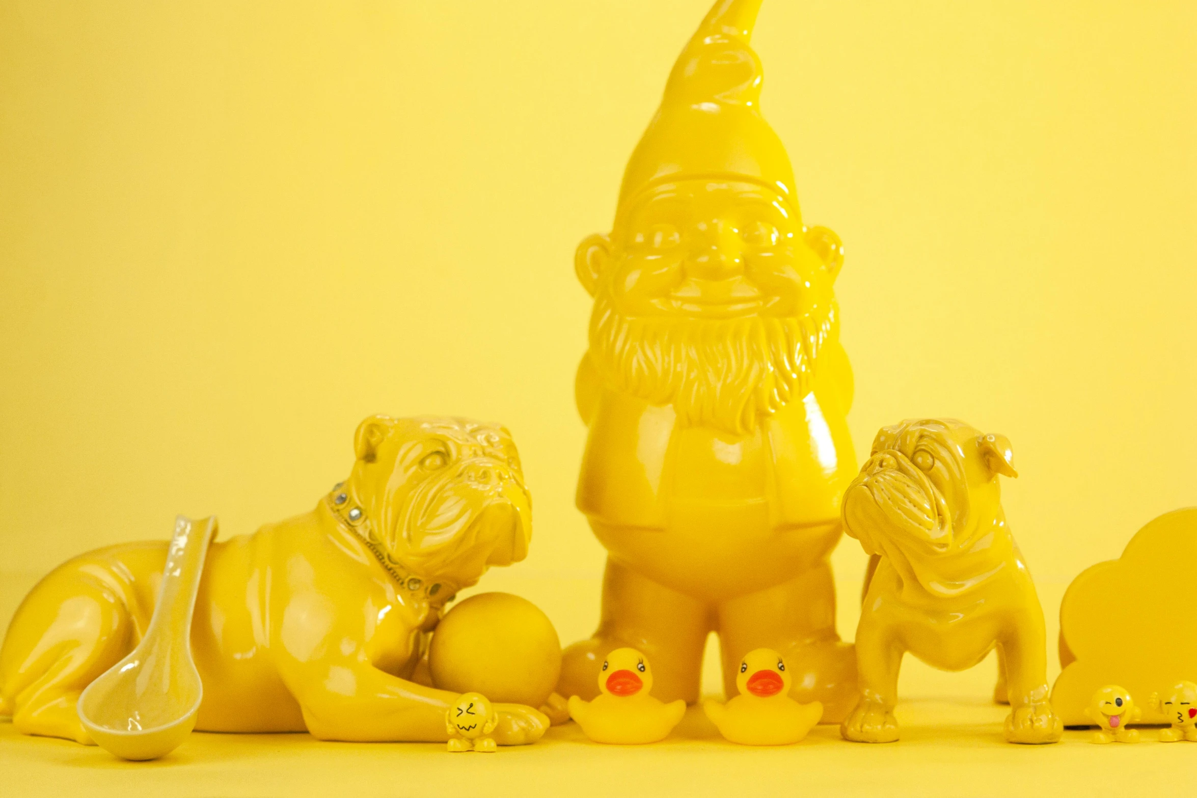 a group of yellow figurines sitting next to each other, gloss finish, gnome, pug, bright light masterpiece