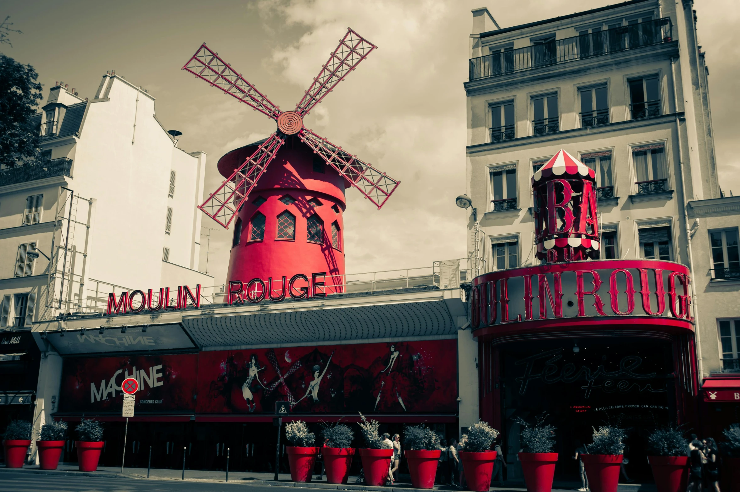 a red building with a windmill on top of it, a photo, inspired by Jules Robert Auguste, pexels contest winner, art nouveau, square, carnival, broadway, cinematic”