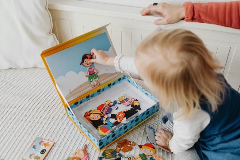 a little girl sitting on the floor playing with a puzzle box, a jigsaw puzzle, by Julia Pishtar, inside its box, magnetic, lady using yellow dress, in cartoon style