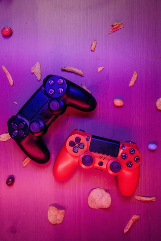 a couple of video game controllers sitting next to each other, by Julia Pishtar, purple and scarlet colours, shot with sony alpha, purple orange colors, multicolored