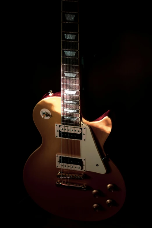 a close up of a guitar in a dark room, an album cover, by Gavin Nolan, pexels contest winner, gold body, trending on mentalray, cream, front flash