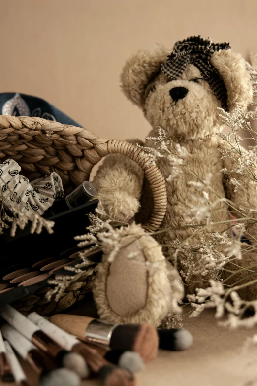 a teddy bear sitting on top of a table next to a basket, a picture, unsplash, renaissance, dried plants, beige, super detailed image, curated collections