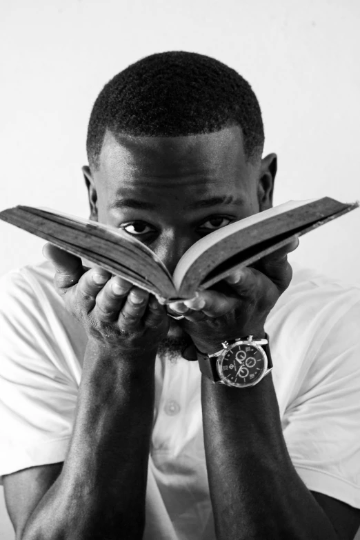 a black and white photo of a man reading a book, frank ocean, father time, : kendrick lamar, black main color