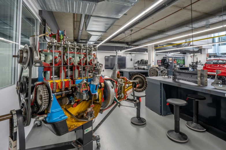 a car engine being worked on in a factory, by Daniel Lieske, pexels contest winner, renaissance, white wall coloured workshop, in an underground laboratory, formula 1 garage, wide long view