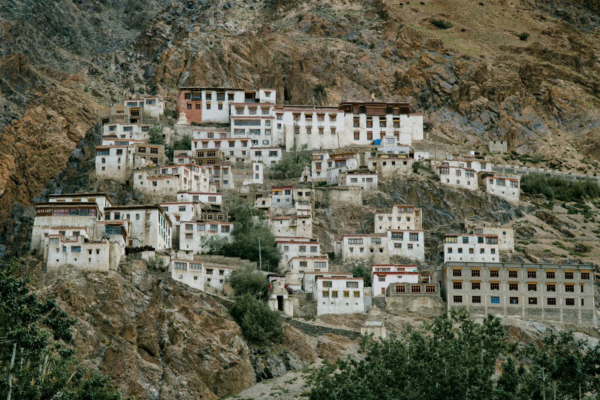 a group of buildings sitting on top of a mountain, a portrait, tibetan inspired architecture, whitewashed buildings, a beautiful mine, shot on hasselblad