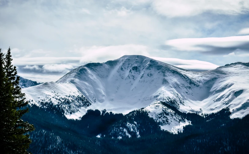 a snow covered mountain with trees in the foreground, by Andrew Domachowski, pexels contest winner, visual art, 4 k cinematic panoramic view, colorado, multiple stories, 2000s photo