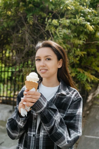 a woman holding an ice cream cone in her hand, pexels contest winner, renaissance, alexandria ocasio - cortez, wearing plaid shirt, portrait sophie mudd, 15081959 21121991 01012000 4k