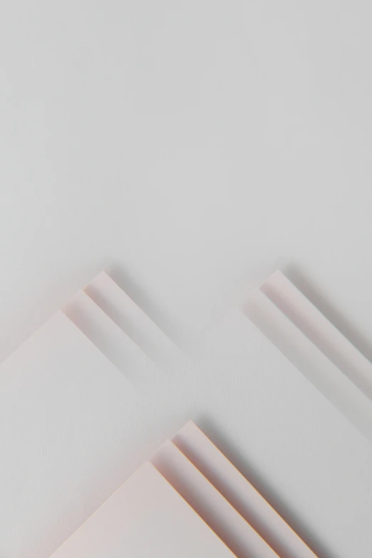 a stack of books sitting on top of a table, by Harvey Quaytman, trending on unsplash, postminimalism, white and pink, square lines, unsplash transparent fractal, zig zag