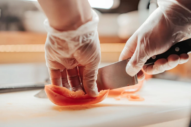 a person cutting a tomato on a cutting board, by Julia Pishtar, pexels contest winner, art nouveau, salmon, closeup of a butcher working, hands on counter, thumbnail